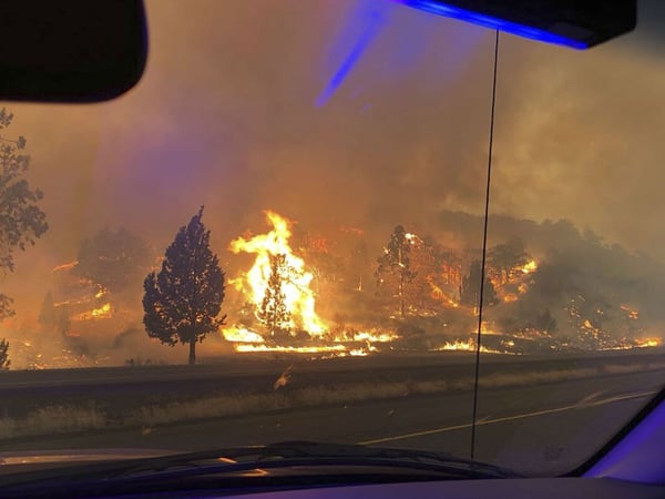 In this photo released Friday, July 6, 2018, by the California Highway Patrol, the Klamathon Fire burns in Hornbrook, Calif.